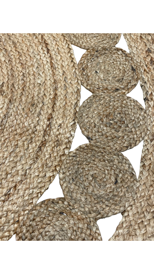 Close up of natural jute rug with large braids in the middle and small jute circles on edge