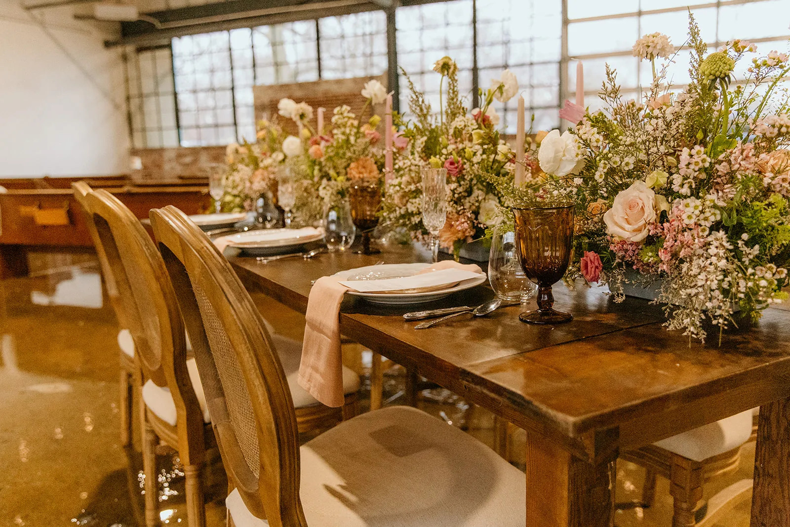 Kingston Farm Table rental for styled shoot WEBP Solid wood farm table, french wooden chairs with cushions - set up for a wedding reception with florals and place settings