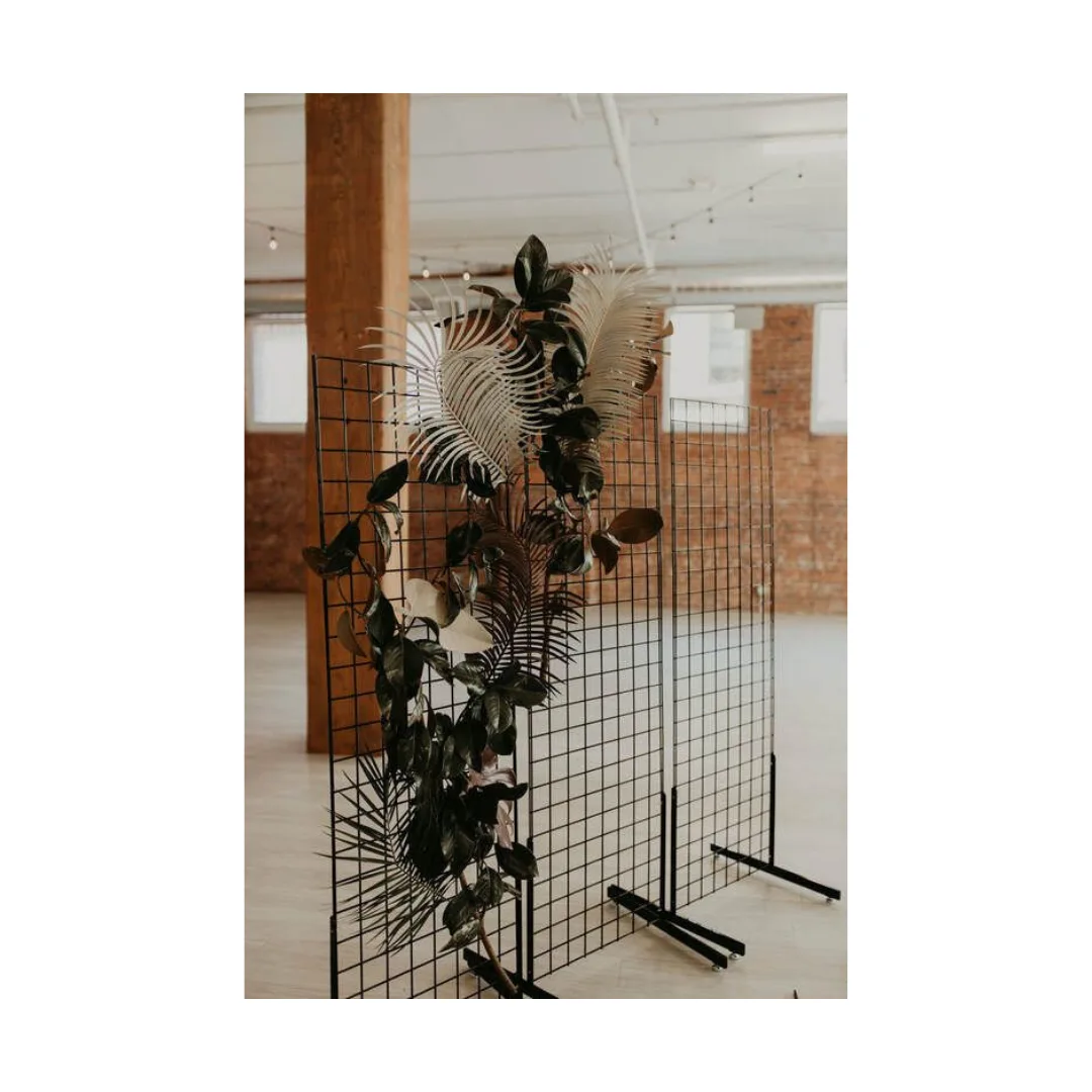 Lowell Black Metal Grid Backdrop WEBP Black wire metal grid - 3 panels together with florals going across from the bottom left up to the middle top panel.