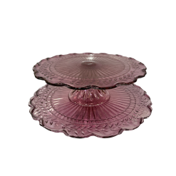 Purple vintage glass cake stands. Glass top with a pedestal leg. Smaller stand is on top of stand with a larger diameter.