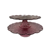 Purple vintage glass cake stands. Glass top with a pedestal leg. Smaller stand is on top of stand with a larger diameter.