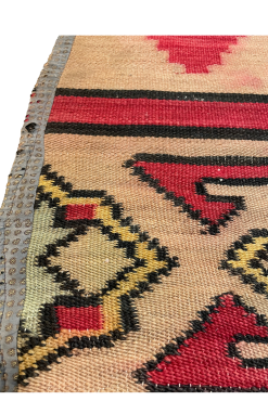 Close up of border area - geometric designs in yellow, blue, red, with black edging.