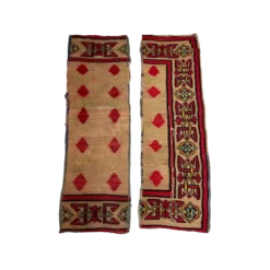 Pair of Maya boho runners. Formerly a full area rug, it has been cut into two strips. Thick border with geometric designs in yellow, green, and red. Large red diamonds in rows inside the border