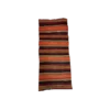 Boho runners with bold stripes in black, orange, red, yellow, and teal. Arial photo of a single runner.