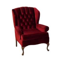 Deep red velvet wing back arm chair. Tufted back with cruved wooden legs.