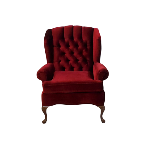 Front view of deep red velvet chair with tufted back, rolled arms, and curved wooden legs.