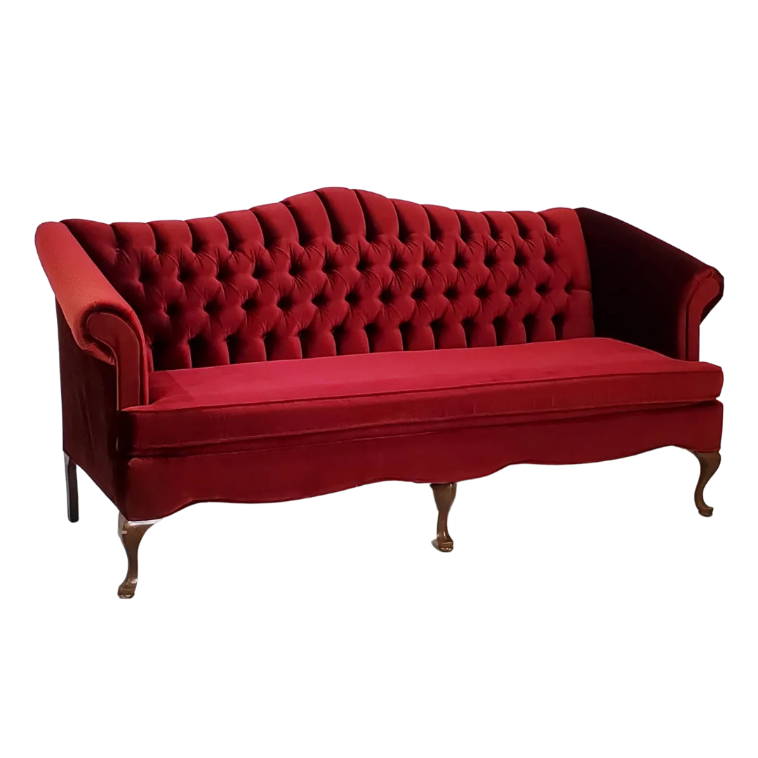 Quinten Sofa angle view WEBP Red velvet sofa, side view. Tufted back, one long cushion. Curved wooden legs