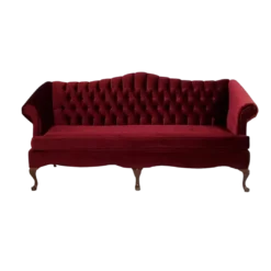 Deep red victorian sofa with button tufted back, rolled arms, curved wooden legs, and 1 long cushion.