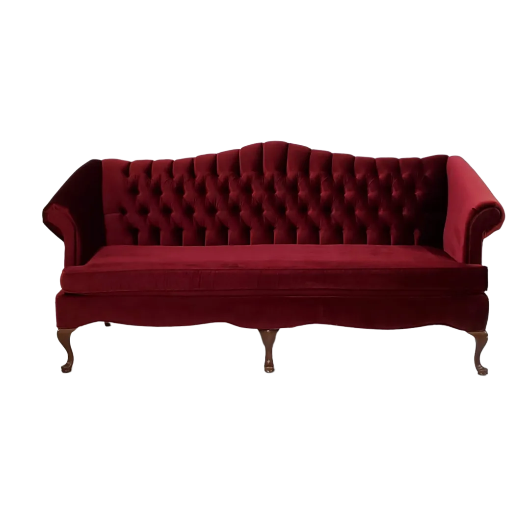 Quinten Sofa front view WEBP Deep red victorian sofa with button tufted back, rolled arms, curved wooden legs, and 1 long cushion.
