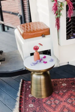 Sade Side table sitting on a rug in a styled shoot