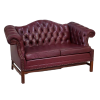 Maroon leather chesterfield loveseat with button tufted back. Side view.