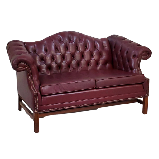 Maroon leather chesterfield loveseat with button tufted back. Side view.