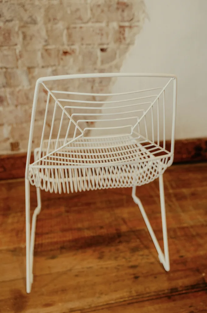 Back of white wire modern metal chair WEBP Back side angle of our modern white wire chair