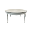 White round vintage coffee table with ornate legs.