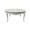 White round vintage coffee table with ornate legs.