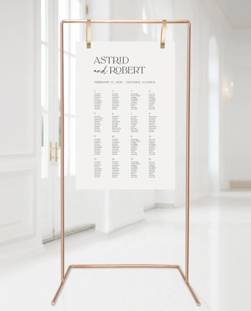 Tall copper stand holding a seating chart at a wedding reception.