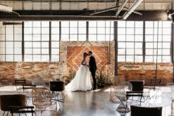 Diamond Shaped backdrop against a brick background with large industrial windows.