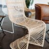 S-shaped rattan wicker chair on concrete floor