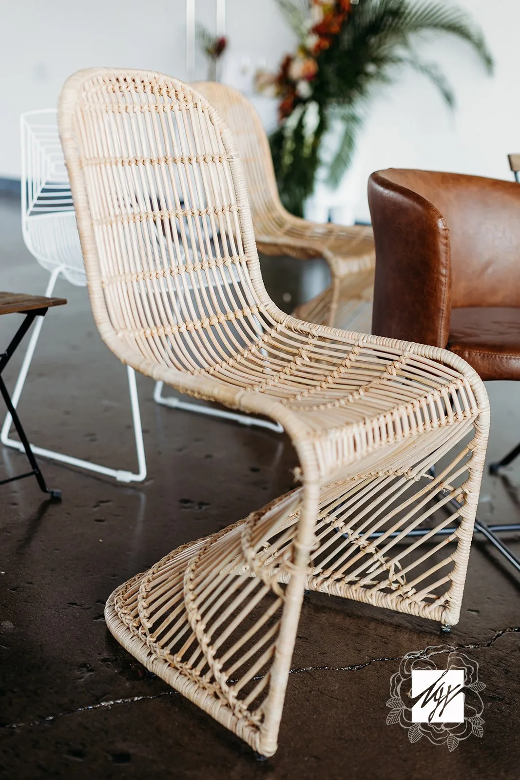 Rattan chair rental WEBP S-shaped rattan wicker chair on concrete floor