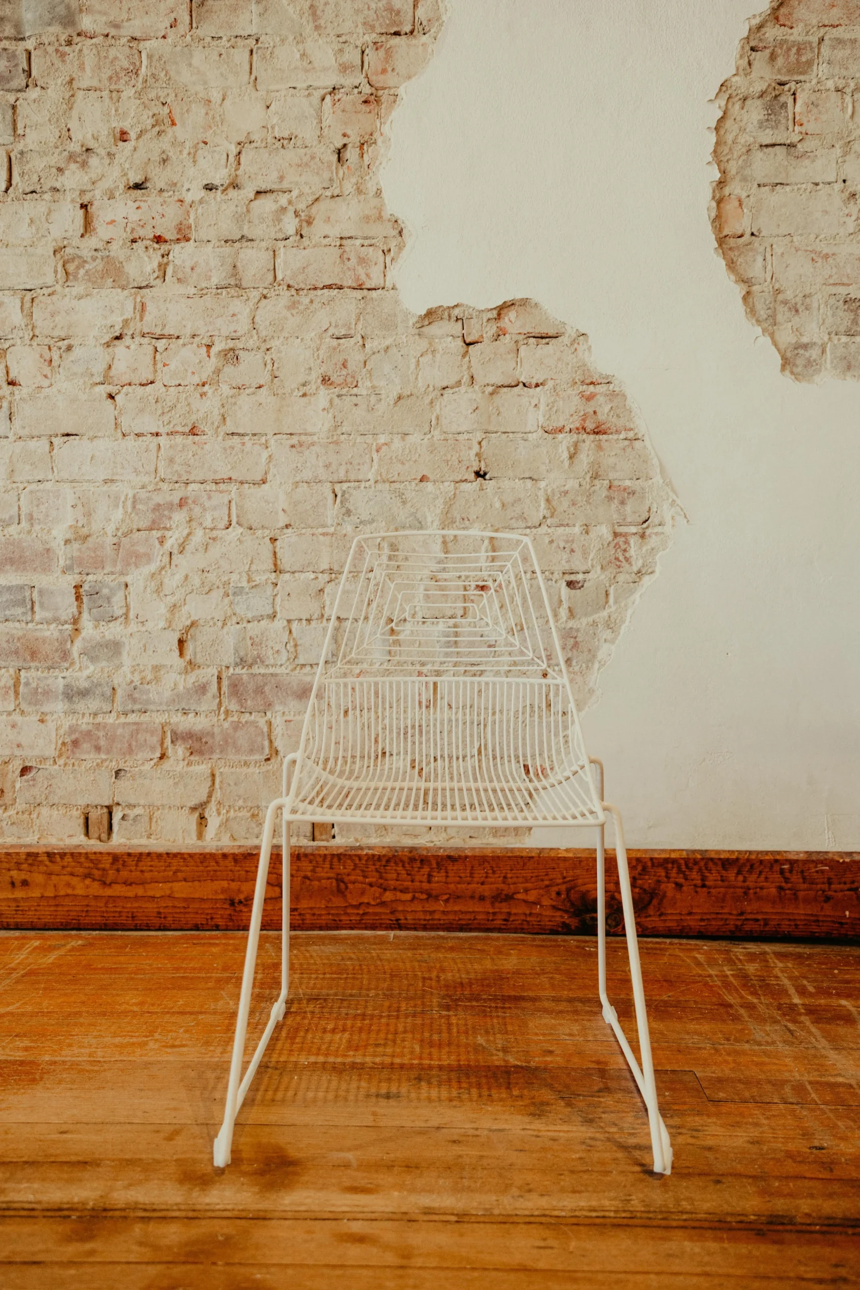 White wire modern chair on brick WEBP
