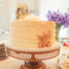 50th anniversary cake - golden shimmer icing sitting on an antique gold lattice cake stand