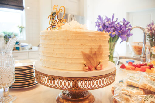 50th anniversary cake - golden shimmer icing sitting on an antique gold lattice cake stand