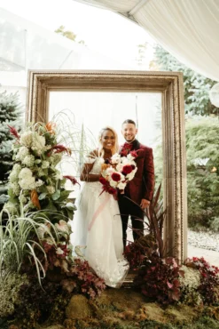 Bride and groom photo shoot with an oversized frame