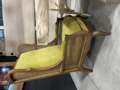 Lime green vintage wingback chair with cane sides at an expo event