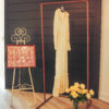 Copper stand holding a wedding dress at 50th anniversary party