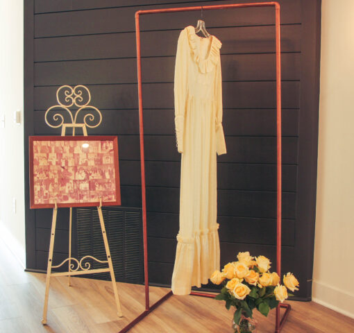 Copper stand holding a wedding dress at 50th anniversary party