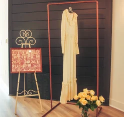 Copper stand holding a wedding dress at 50th anniversary party