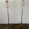 Two matching copper floor standing candle sticks