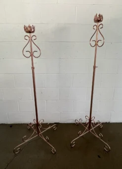 Two matching copper floor standing candle sticks