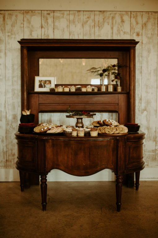 Desk and mantle used as dessert display at barn wedding at Wild Blackberry Farms