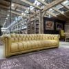 Yellow vintage leather chair with a purple area rug at an expo event