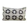 Rectangular pillow with tan background and black southwest designs. Two rows of 3