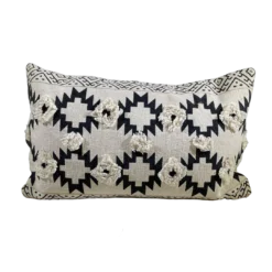 Rectangular pillow with tan background and black southwest designs. Two rows of 3