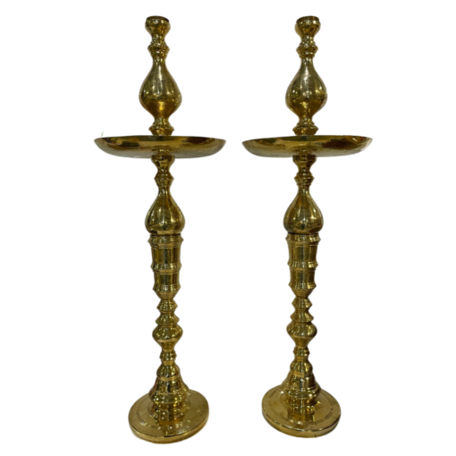 Tall gold decor shaped like a candlestick with a round plate 3/4 of the way to the top.