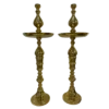 Tall gold decor shaped like a candlestick with a round plate 3/4 of the way to the top.