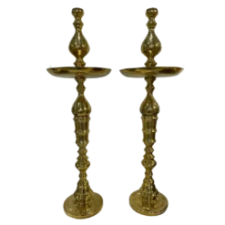 Tall gold decor shaped like a candlestick with a round plate 3/4 of the way to the top.