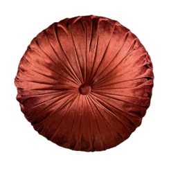 Burnt orange round velvet pillow with a button in the middle