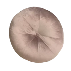 Oversized light pink round velvet pillow cushion with a button in the middle.
