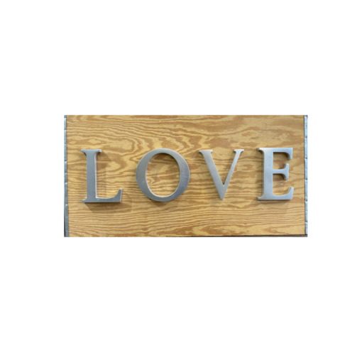 Wood with silver capital letters spelling LOVE