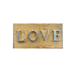 Wood with silver capital letters spelling LOVE