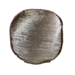 Shimmery rose gold round pillow with pink stitching around circumference.