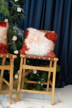 Stafford Pillow for rent at Violet Vintage Indianapolis: A square, high-texture faux fur decorative pillow featuring a soft color-blocked pattern of rust orange and creamy white long-pile fur for event lounge styling.