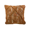 Square off white pillow with burnt orange / rust colored macrame in designs over the pillow.