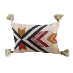 Rectangular pillow with bold lines and angles. Tassels on the corners