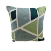 Pillow with geometric shapes in green, light blue, dark blue with white lines between shapes
