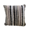 Striped pillow in beige with black, brown, tan, and light blue stripes